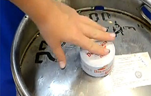 Put the shrink band with the top disc onto the beer keg fitting